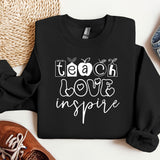 a black sweatshirt with the words teach love inspire on it