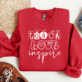 a red sweatshirt with the words teach love inspire on it
