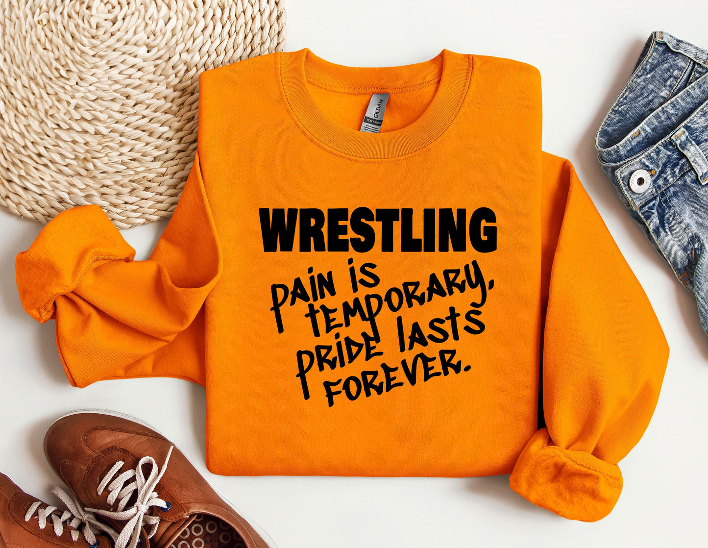 a pair of sneakers and a sweatshirt with the words wrestling on it