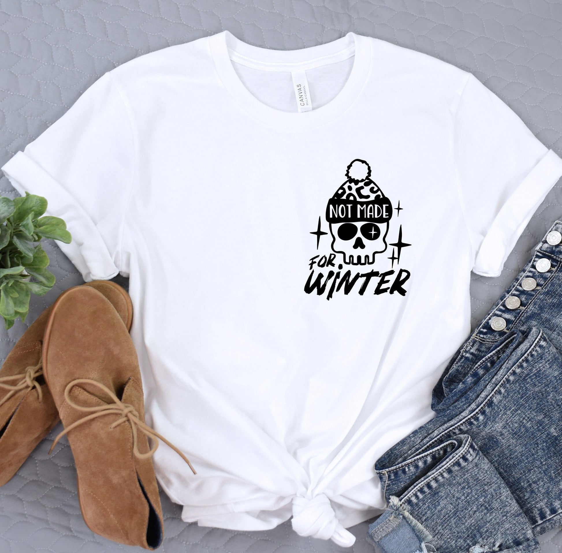 a white t - shirt with a skull on it