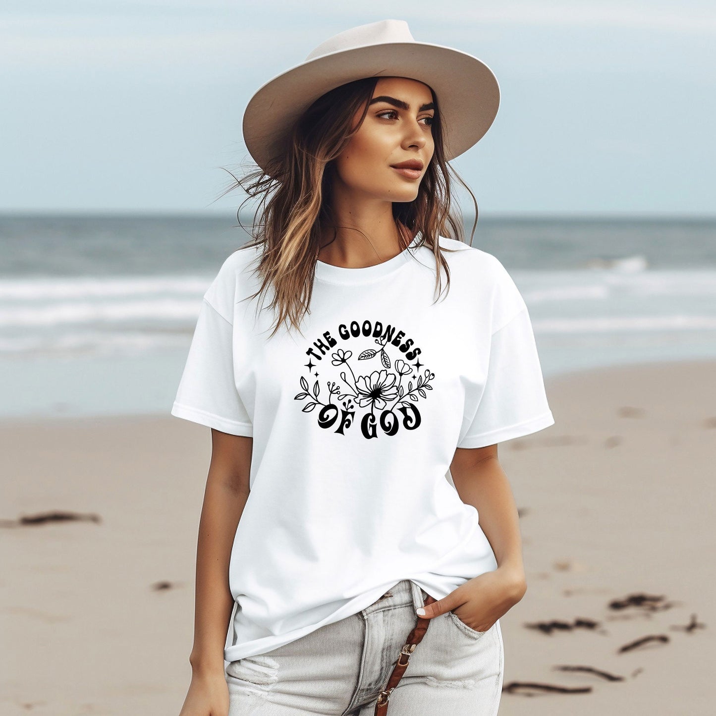 a woman standing on a beach wearing a hat