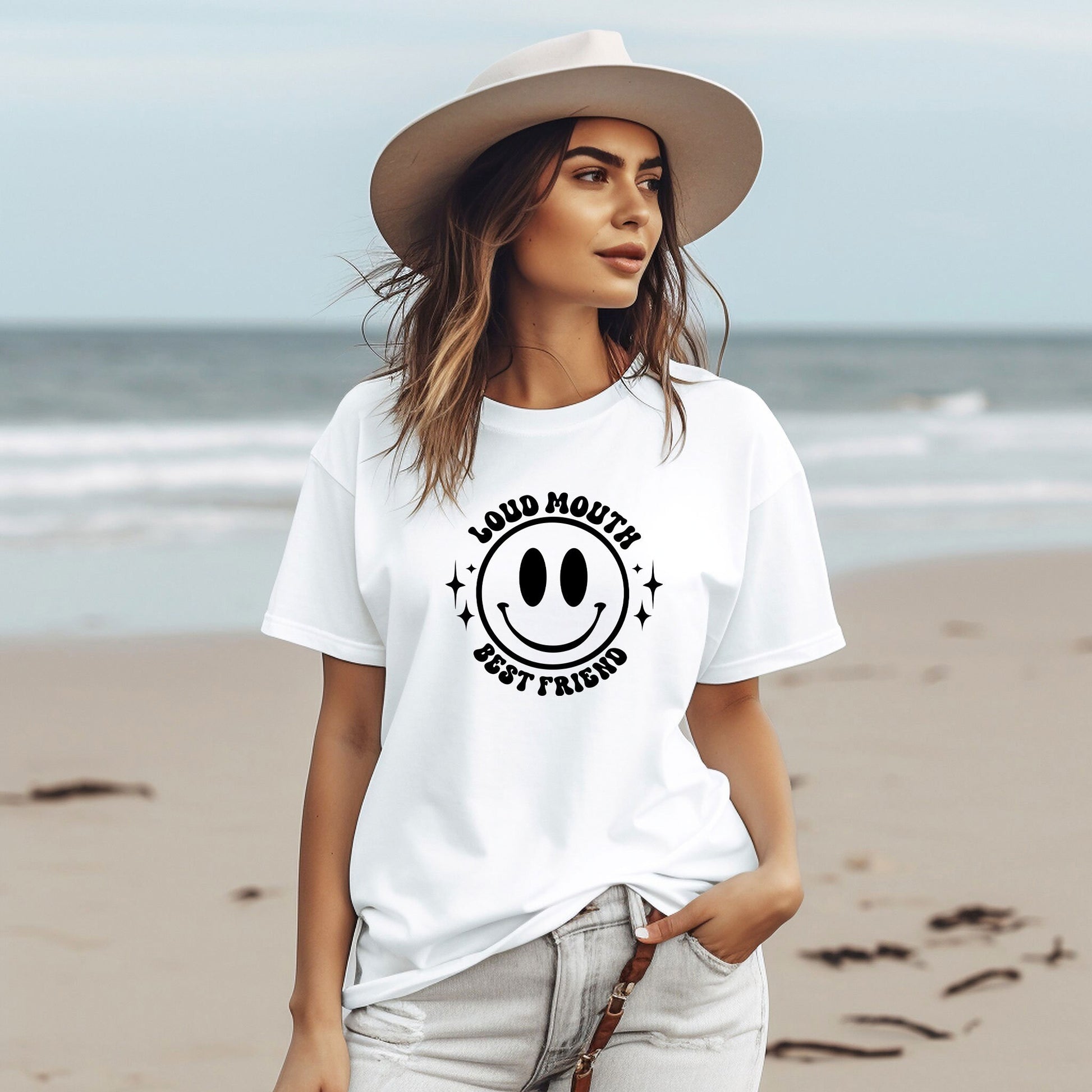 a woman wearing a white t - shirt with a smiley face on it