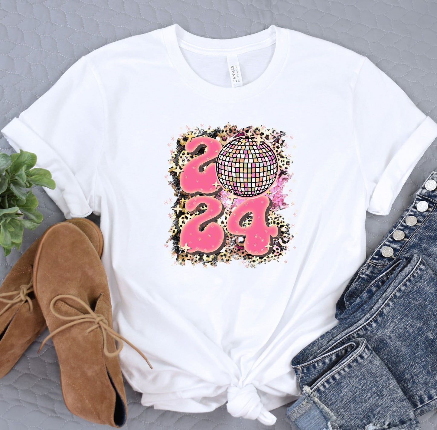 a white t - shirt with a pink design on it