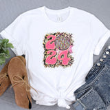 a white t - shirt with a pink design on it