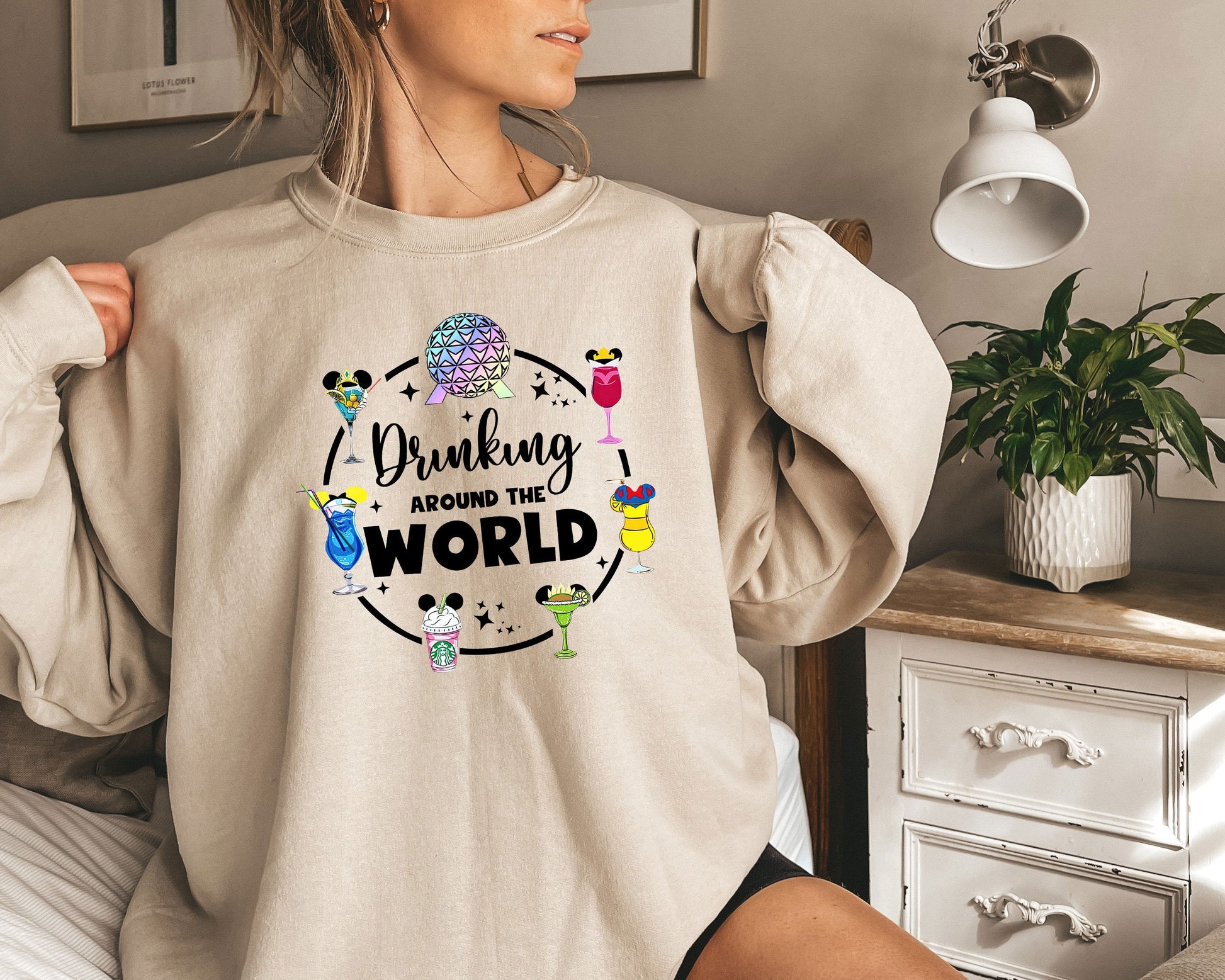 a woman wearing a sweatshirt that says drinking around the world