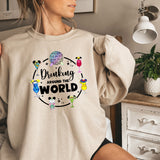 a woman wearing a sweatshirt that says drinking around the world