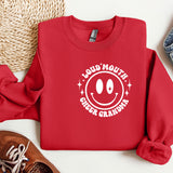 a red sweatshirt with a smiley face on it