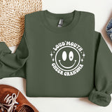 a green sweatshirt with a smiley face on it