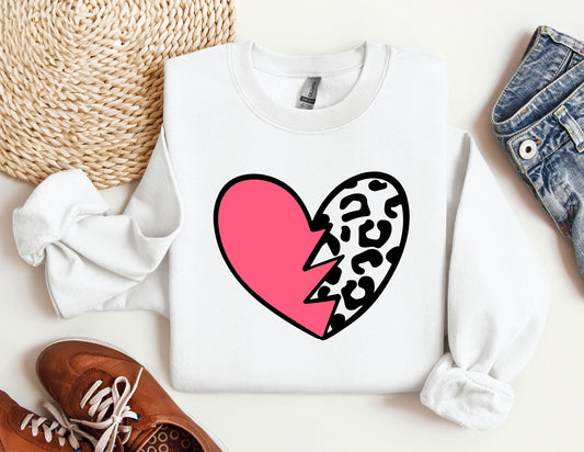 a white sweater with a pink heart and a leopard print