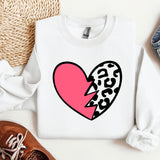 a white sweater with a pink heart and a leopard print