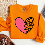 a sweater with a heart and a leopard print on it