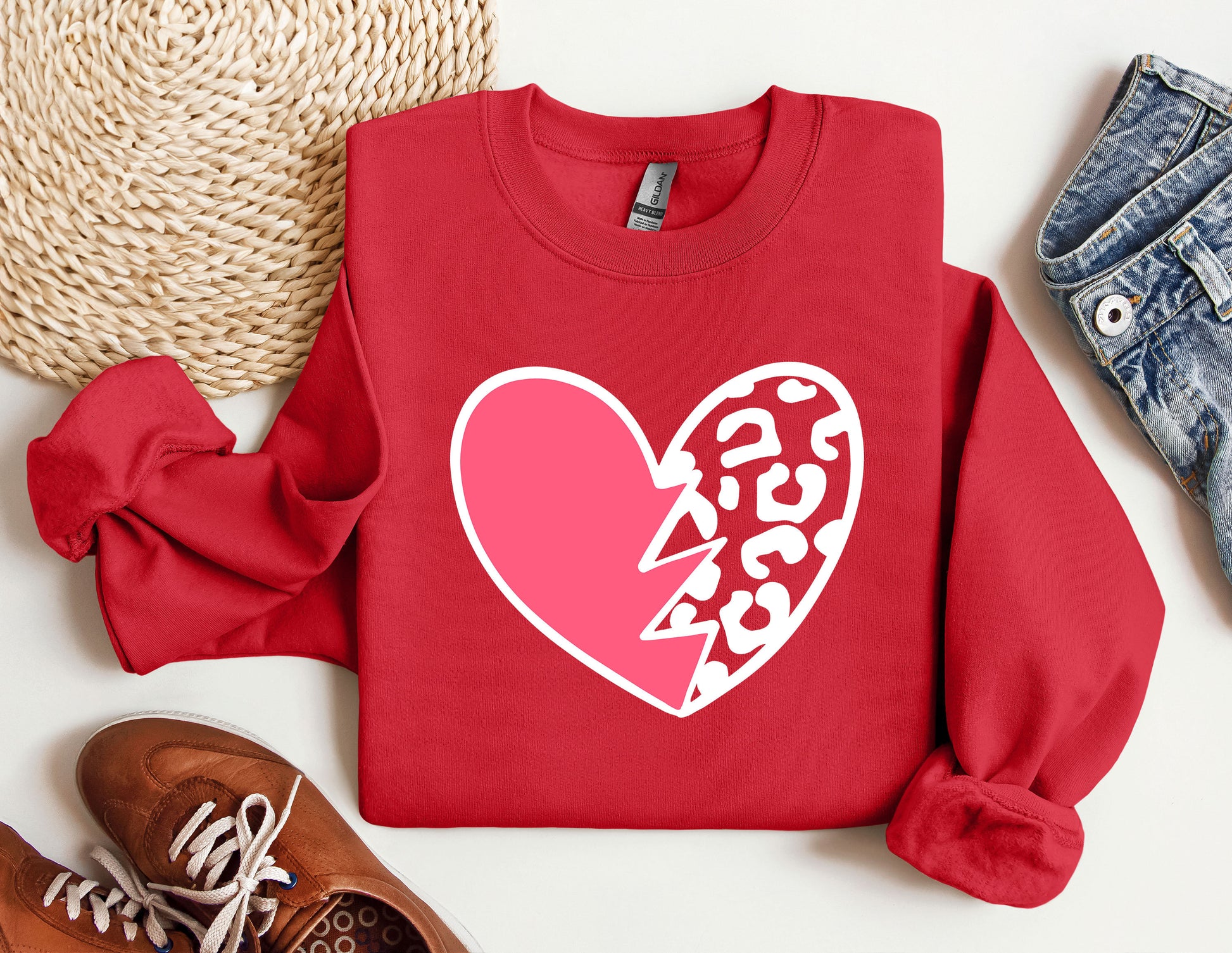 a red sweatshirt with a heart and lightning bolt on it