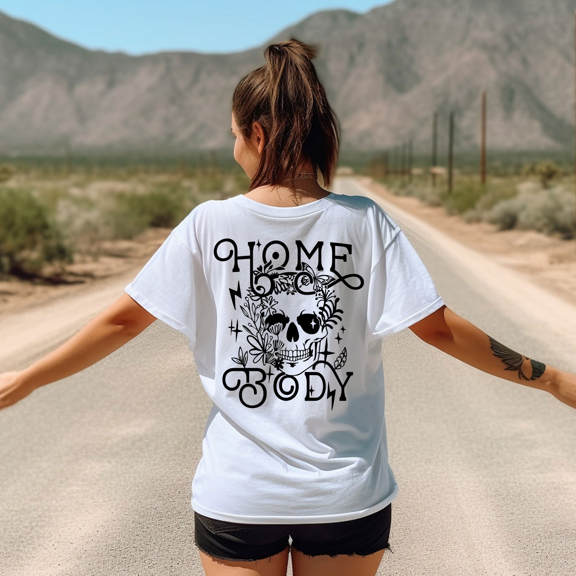 a woman walking down a road with her arms outstretched