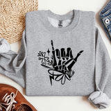a gray sweatshirt with a black hand drawn on it