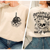 a woman wearing a sweatshirt with a skull and flowers on it
