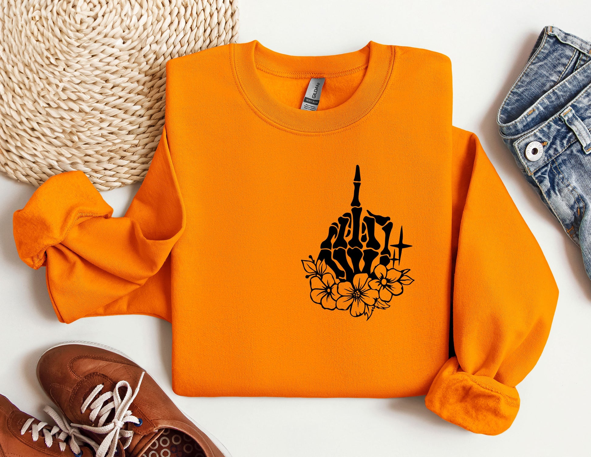 an orange sweatshirt with a picture of a building on it