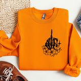 an orange sweatshirt with a picture of a building on it