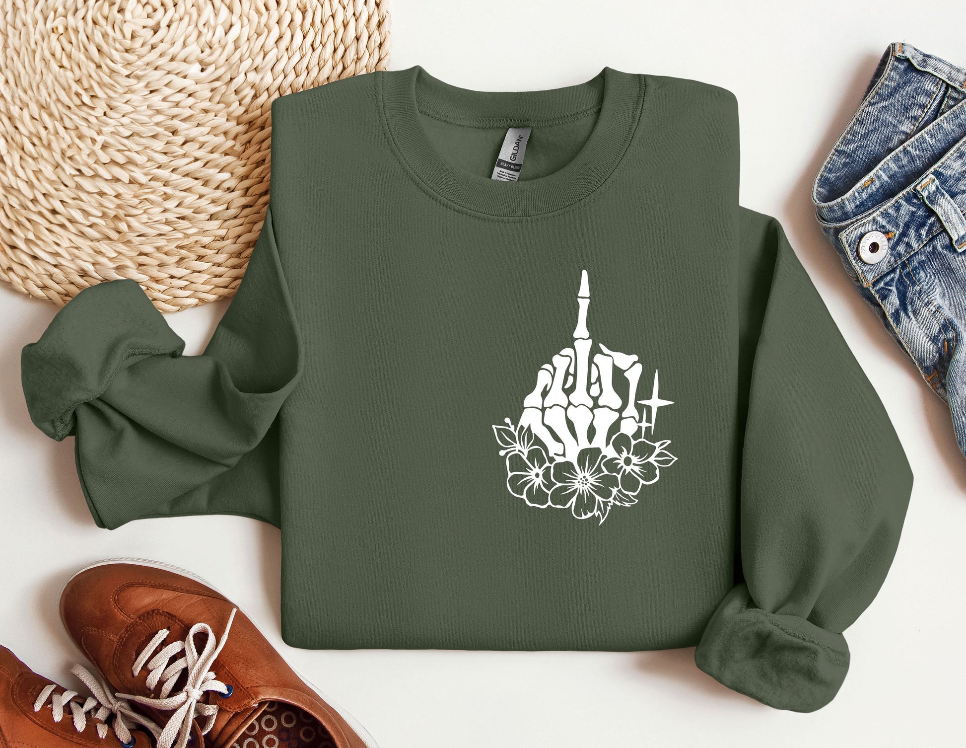 a green sweatshirt with a picture of a building and flowers on it