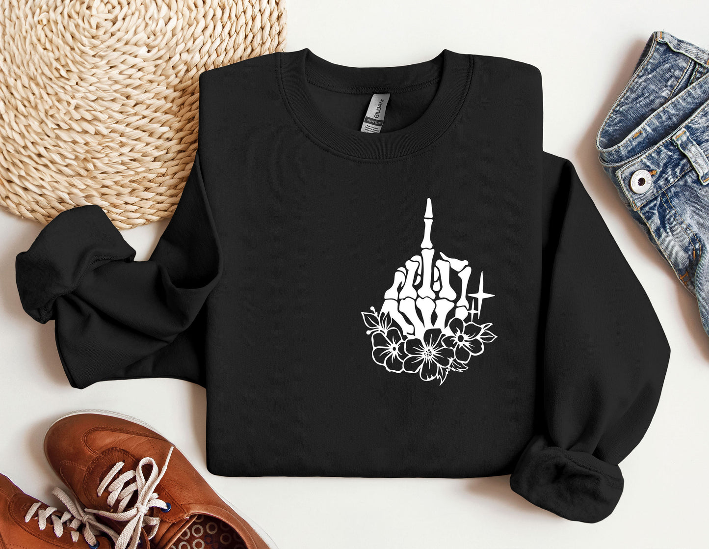 a black sweatshirt with a picture of a building and flowers on it