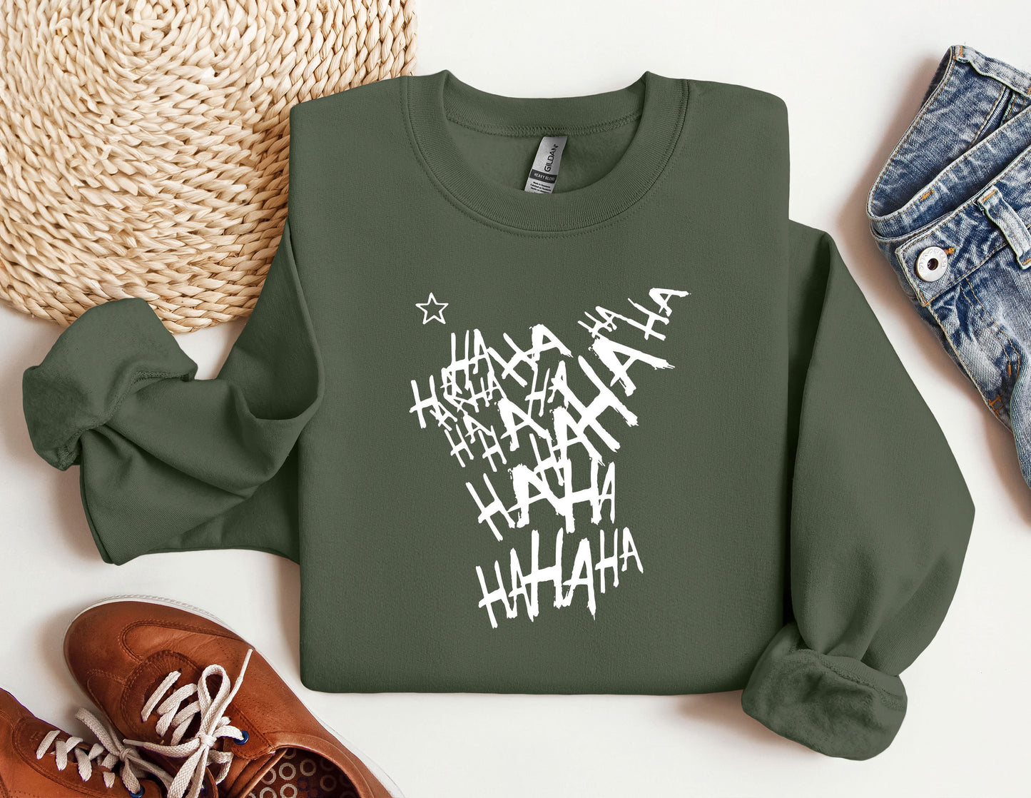 a green sweatshirt with white writing on it next to a pair of shoes