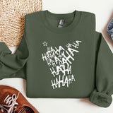 a green sweatshirt with white writing on it next to a pair of shoes