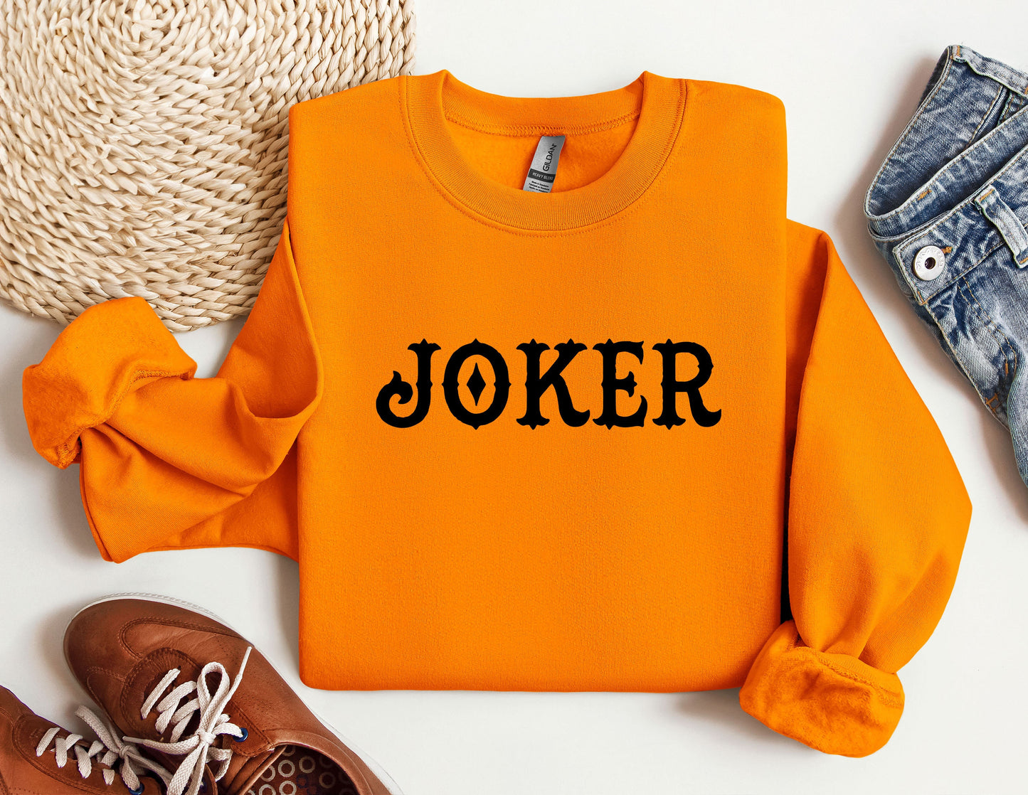 an orange sweater with the word joker printed on it