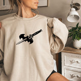 a woman wearing a sweatshirt with a sword on it