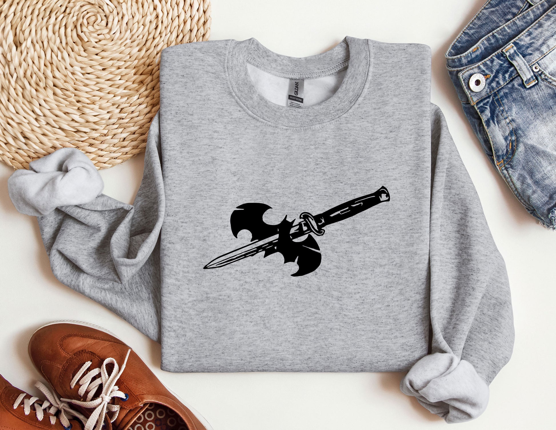 a gray sweatshirt with a black sword on it