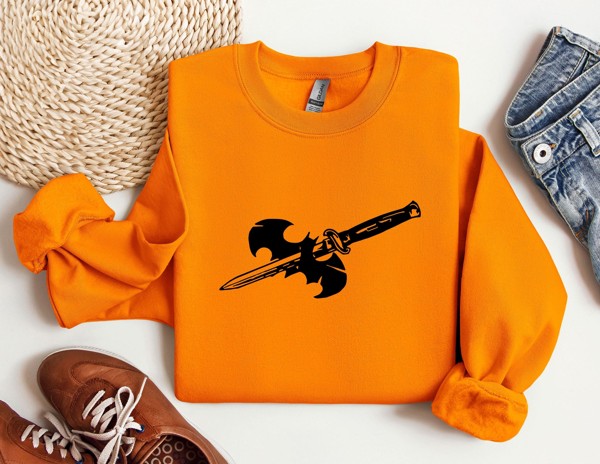 an orange shirt with a sword on it