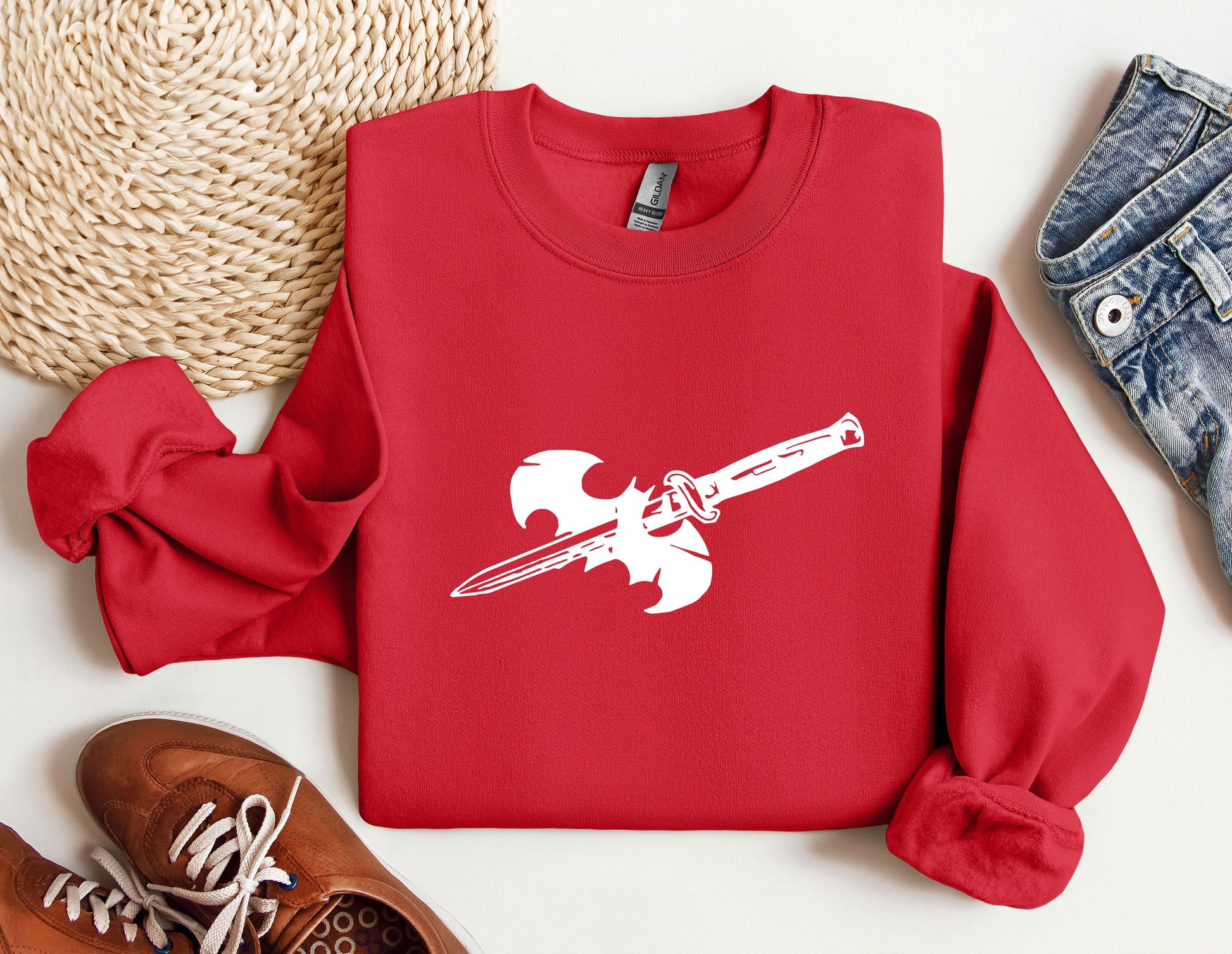 a red sweatshirt with a sword on it