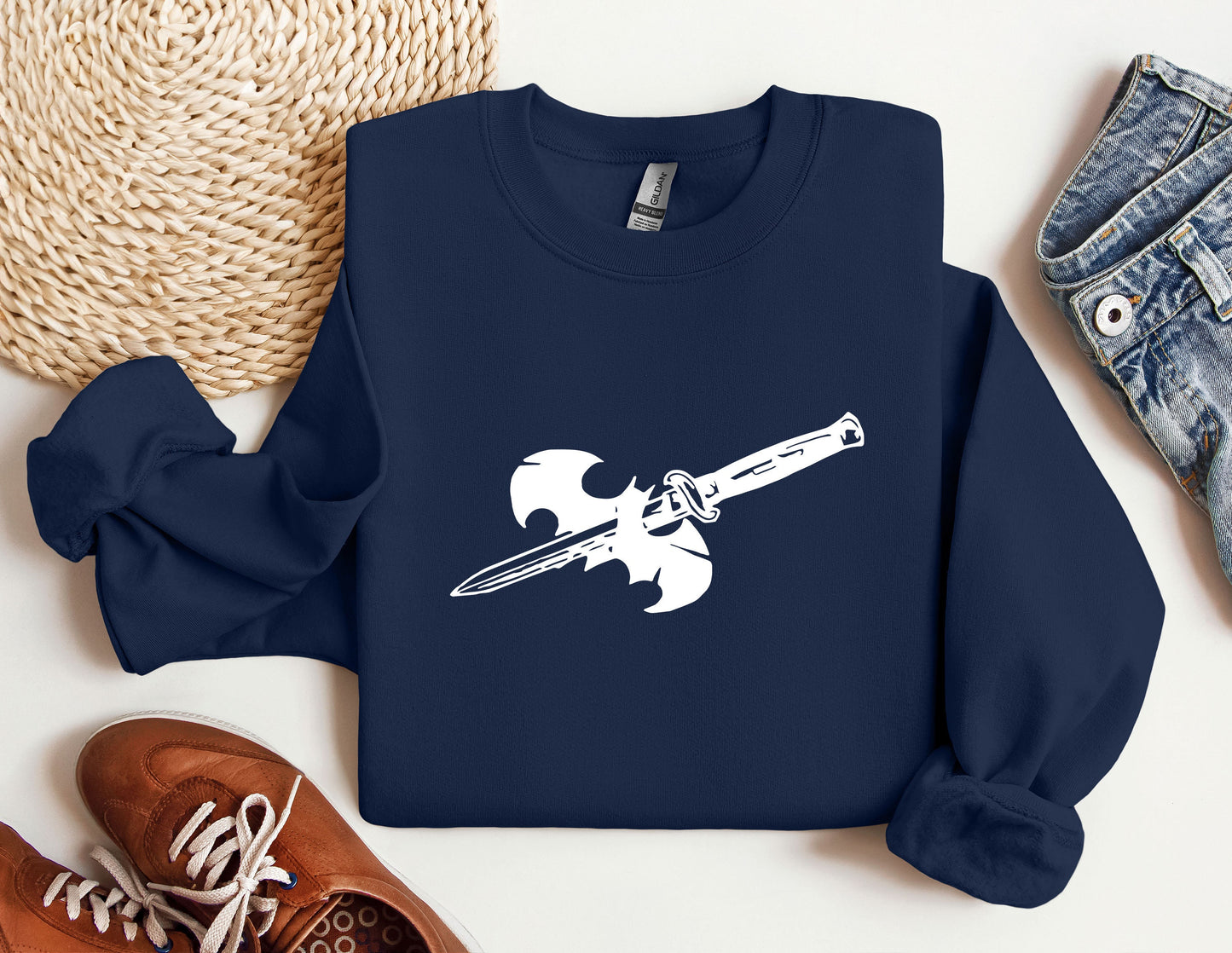 a blue sweatshirt with a white sword on it