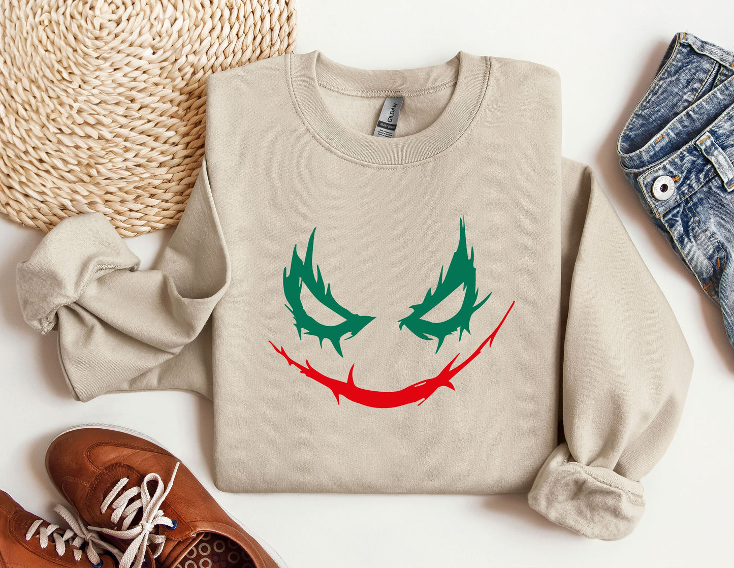 a sweater with a joker face drawn on it