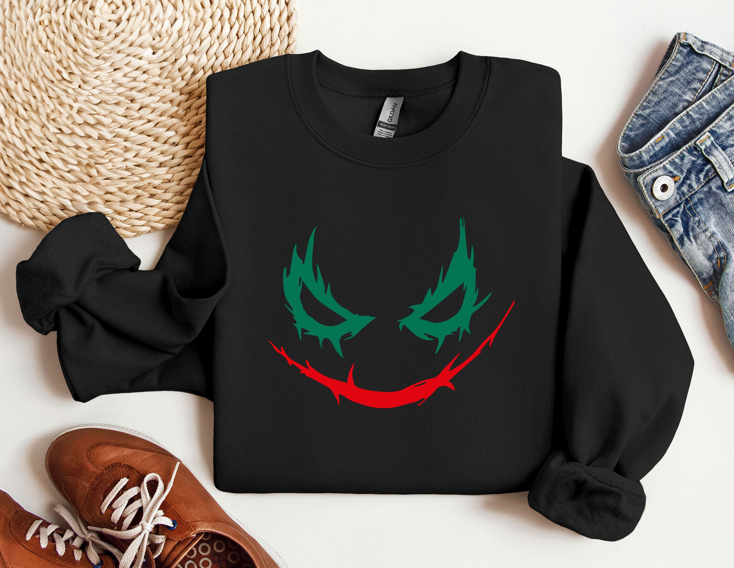 a black sweatshirt with a green and red face