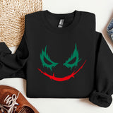 a black sweatshirt with a green and red face