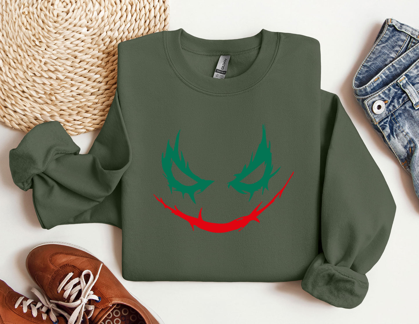 a green sweatshirt with a red and green face on it