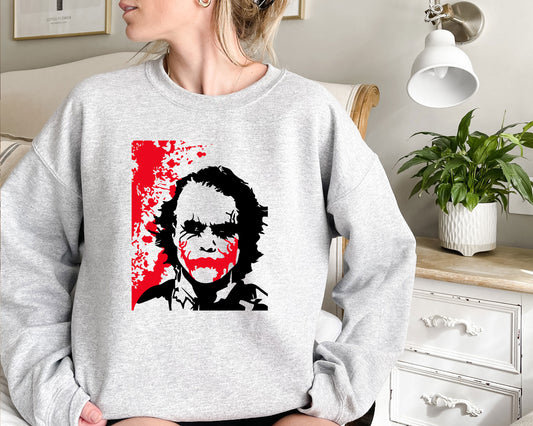 a woman wearing a sweatshirt with a picture of a man on it