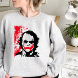 a woman wearing a sweatshirt with a picture of a man on it