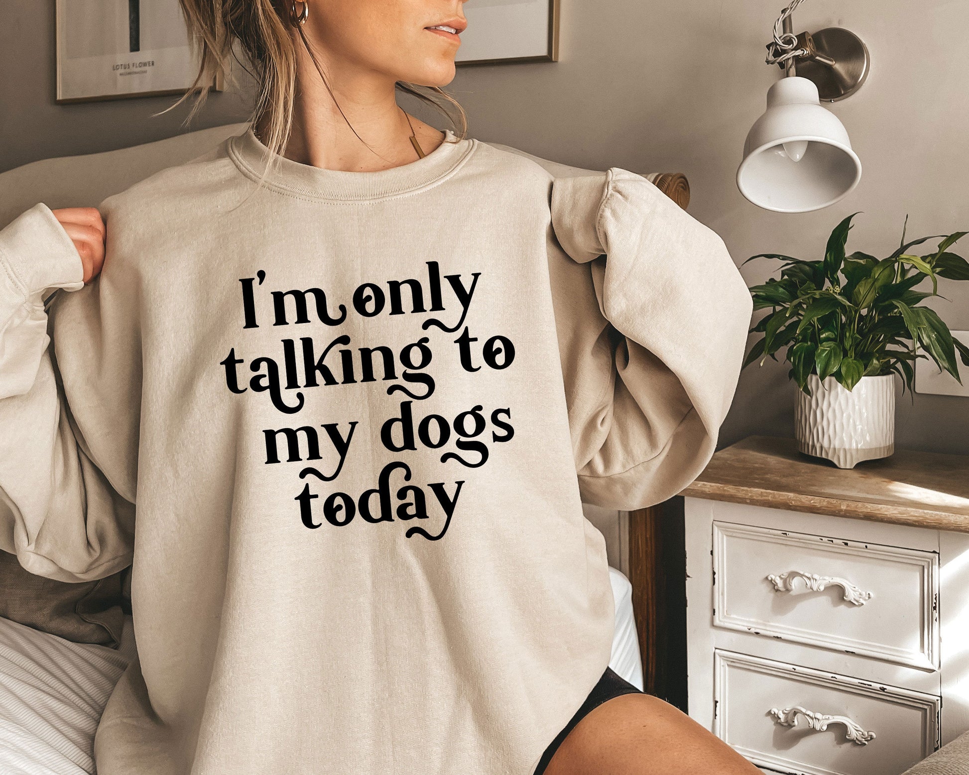 a woman wearing a sweatshirt that says i&#39;m only talking to my dogs today