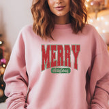 a woman wearing a pink merry christmas sweatshirt