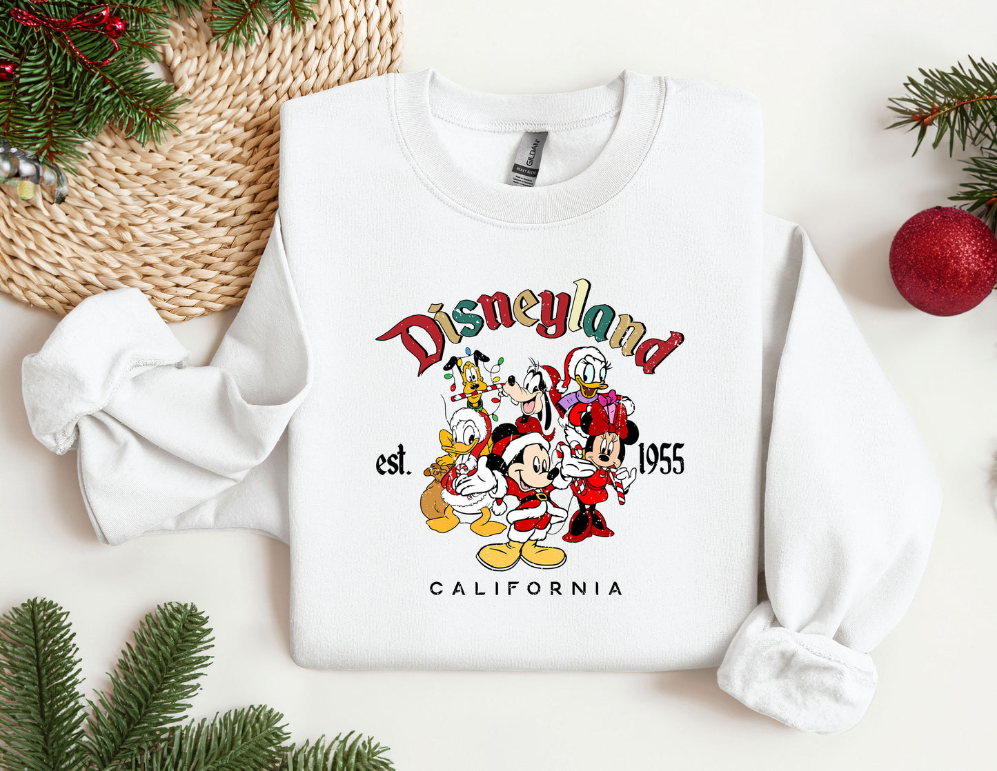 a white sweatshirt with mickey mouse and friends on it