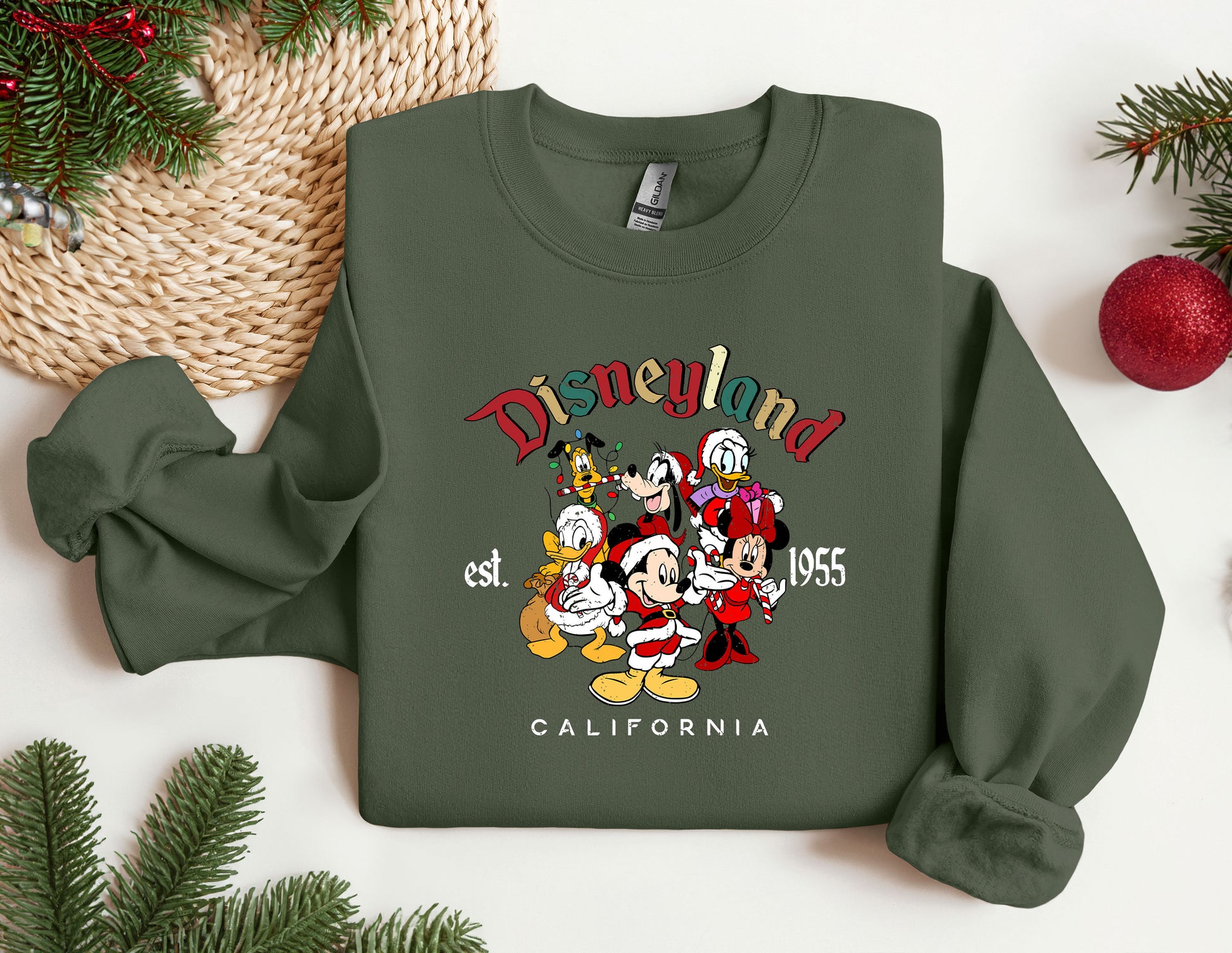 a green sweatshirt with mickey mouse and friends on it