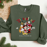 a green sweatshirt with mickey mouse and friends on it