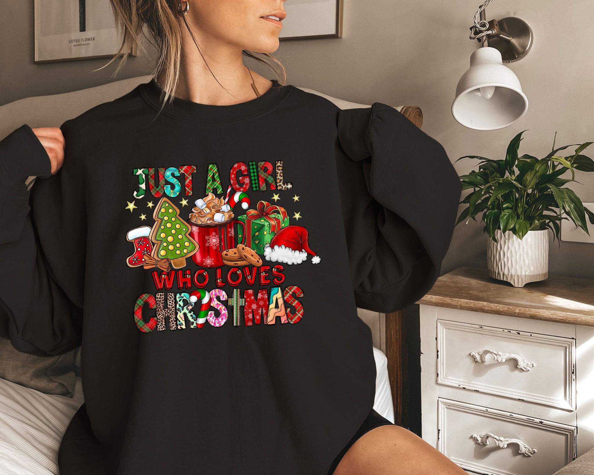 a woman wearing a black shirt with a christmas message on it