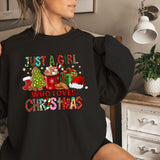 a woman wearing a black shirt with a christmas message on it