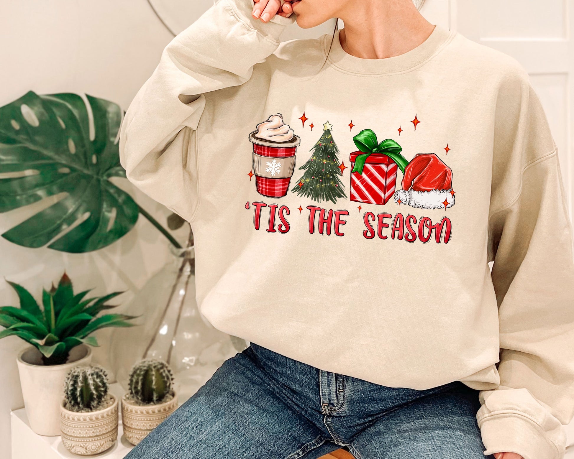 a woman sitting on a chair wearing a sweatshirt