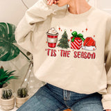a woman sitting on a chair wearing a sweatshirt