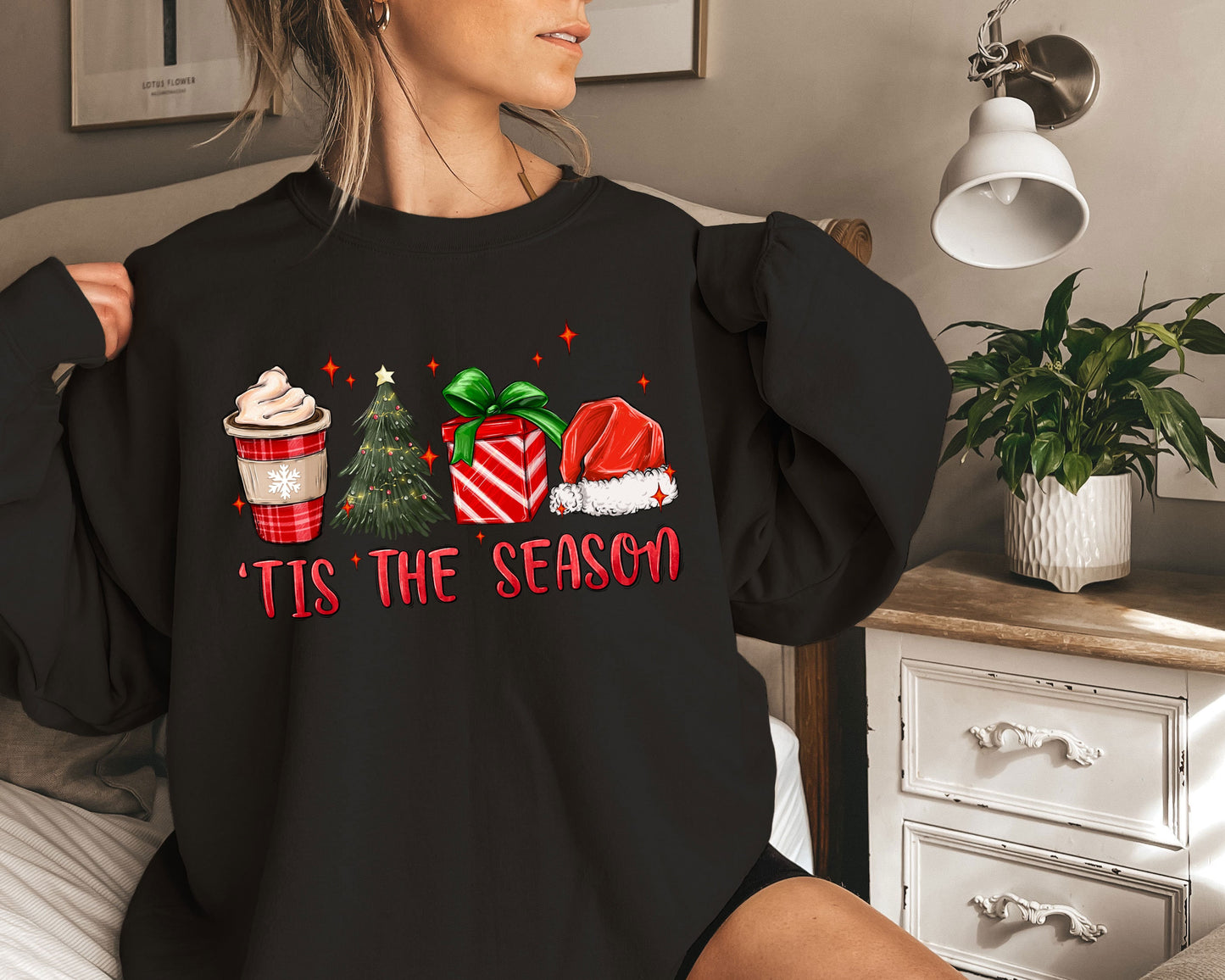 a woman wearing a black shirt that says tis the season