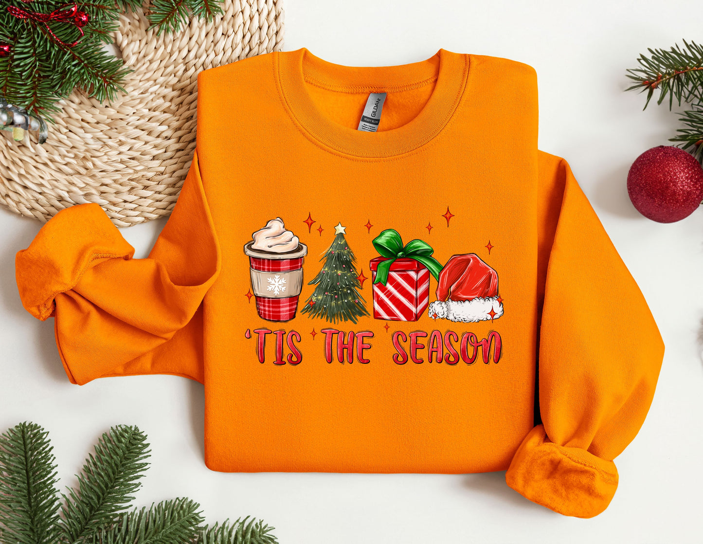 an orange sweater with a cup of coffee on it