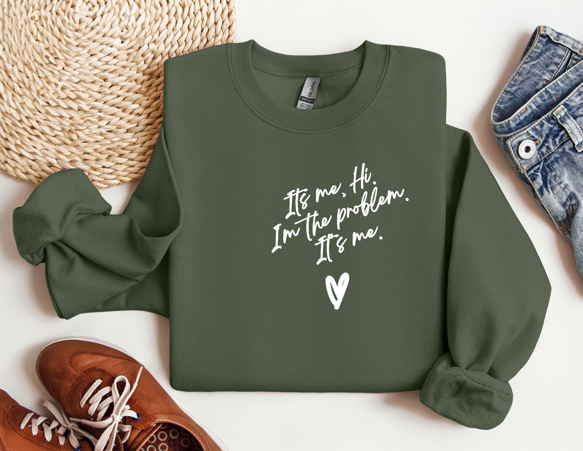 a green sweatshirt with a heart and a pair of shoes