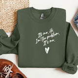 a green sweatshirt with a heart and a pair of shoes